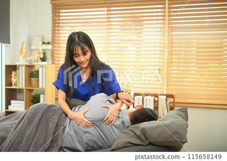 Physiotherapist treating shoulder blades on young male patient during an appointment at clinic 115658149