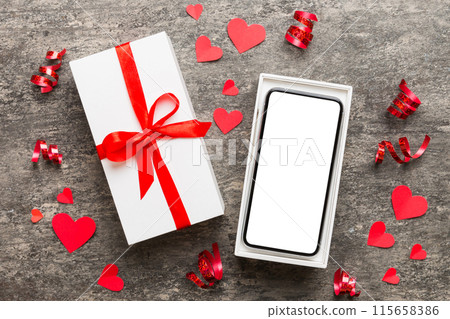Opened gift box with ribbon and phone on color background, top view. Blank open box packaging mockup , Template for your design - branding mockup Opened gift box with ribbon and phone on color background, top view. Blank open box packaging mockup , Template for your design - branding mockup 115658386