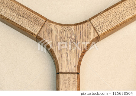 Triple jointed wooden frame of the table is made of solid oak closeup 115658504