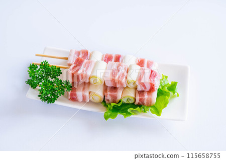 Pork belly skewer with green onions 115658755