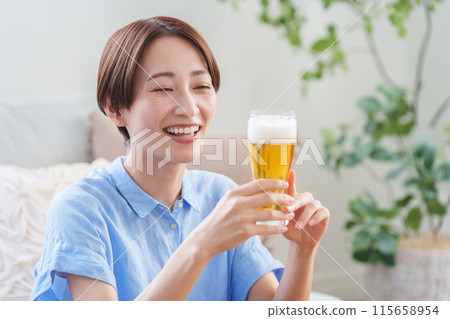 Woman drinking beer in summer 115658954