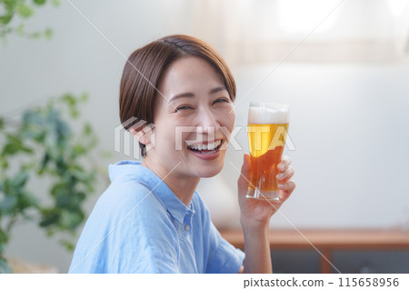 Woman drinking beer in summer 115658956