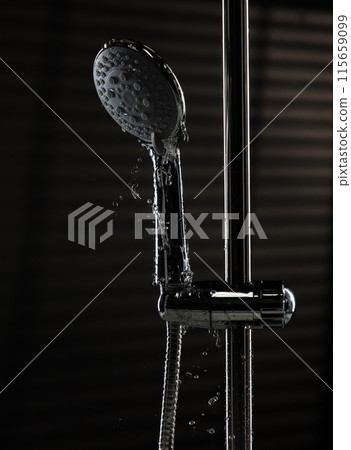 Shower head leak water from hoses plumbing in bathroom as water clogged drop. Black background isolated. Leaking water from chromium stainless steel shower head Shower head leak water from hoses plumbing in bathroom as water clogged drop. Black background isolated. Leaking water from chromium stainless steel shower head 115659099