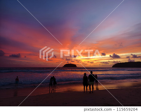 Beautiful sunset on the ocean shore with a view of the islands Beautiful sunset on the ocean shore with a view of the islands 115659204