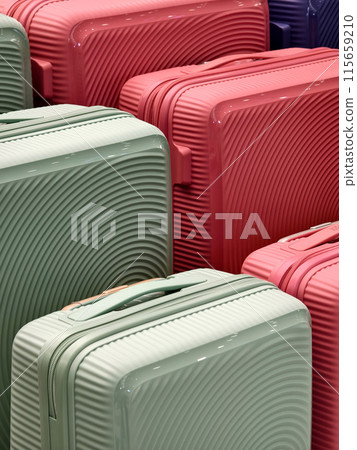 A vibrant assortment of suitcases is carefully arranged in a pile A vibrant assortment of suitcases is carefully arranged in a pile 115659210