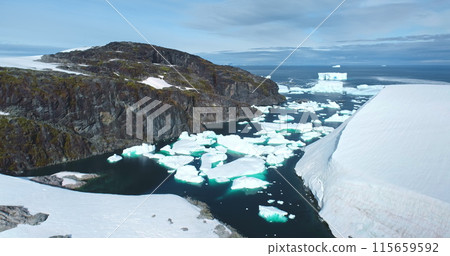 Group of icebergs melting glacier floating in Antarctic mountain rock canyon bay frozen river. Polar winter ocean landscape in sunny day. Antarctica travel exploration. Aerial view rise up panorama. 115659592