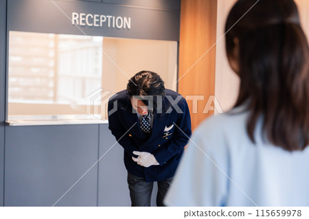 Hotel staff apologizing to customers Hotel staff apologizing to customers 115659978