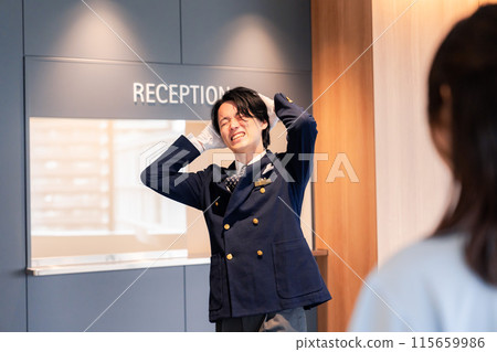 Hotel staff apologizing to customers 115659986