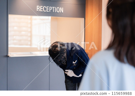 Hotel staff apologizing to customers Hotel staff apologizing to customers 115659988