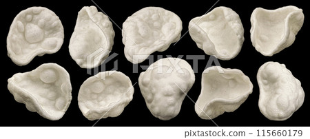 White starch potato chips, salty puffed snacks isolated on black background with copy space, full depth of field 115660179