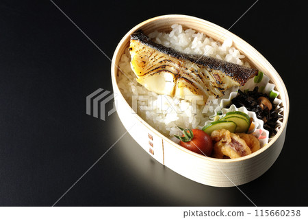 A bento box of grilled cod in saikyo-yaki style served in a bento box photographed against a black background A bento box of grilled cod in saikyo-yaki style served in a bento box photographed against a black background 115660238