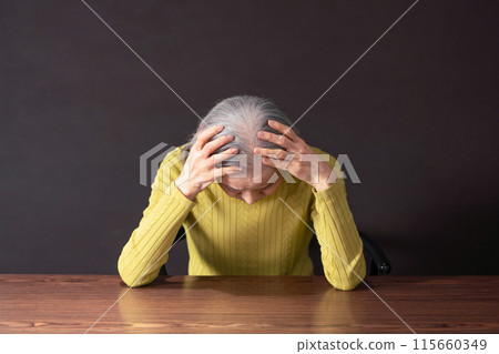 Senior woman holding a head Senior woman holding a head 115660349