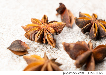 Spice star anise closeup on gray stone background 115660422