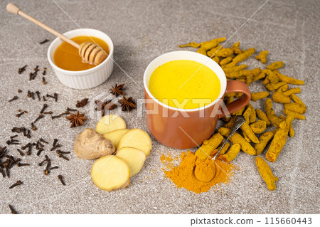 Natural Ayurvedic drink golden milk with turmeric and spices in a mug 115660443