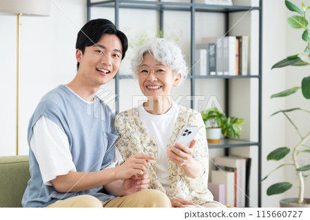 Grandmother and grandson relaxing in the living room Grandmother and grandson relaxing in the living room 115660727