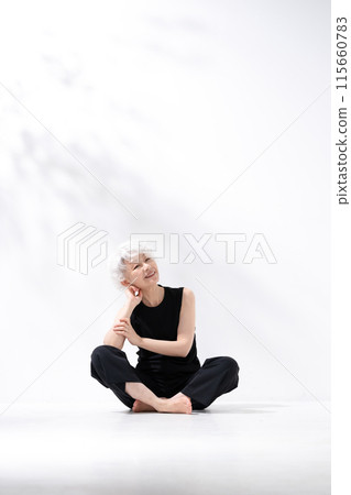 Gray-haired woman, full body, sitting, cross-legged 115660783