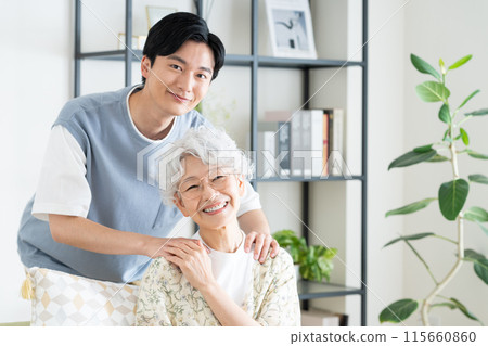 Grandmother and grandson relaxing in the living room 115660860