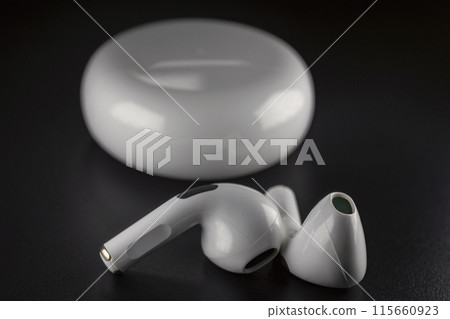 ROSTOV-ON-DON, RUSSIA - APRIL 28, 2018: Apple AirPods wireless Bluetooth headphones and charging case for Apple iPhone. New Apple Earpods Airpods in box. ROSTOV-ON-DON, RUSSIA - APRIL 28, 2018: Apple AirPods wireless Bluetooth headphones and charging case for Apple iPhone. New Apple Earpods Airpods in box. 115660923
