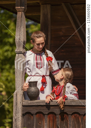 mother and daughter dressed in Ukrainian national costumes 115660932