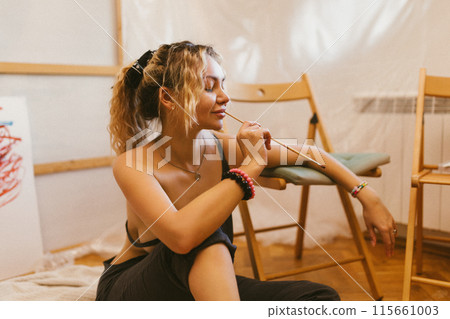 sexy artist paints on canvas with her back naked. sexy artist paints on canvas with her back naked. 115661003