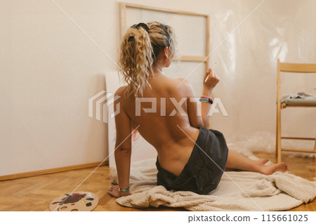 sexy artist paints on canvas with her back naked. sexy artist paints on canvas with her back naked. 115661025