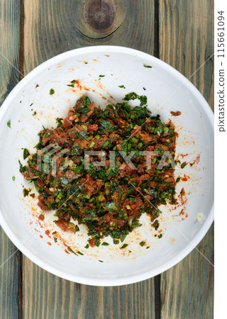 Gremolata seasoning made from finely chopped parsley, crushed garlic, sun-dried tomatoes and mint leaves. Gremolata seasoning made from finely chopped parsley, crushed garlic, sun-dried tomatoes and mint leaves. 115661094