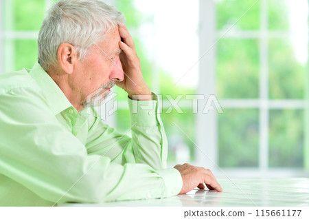 close-up portrait of a senior man thinking about something 115661177