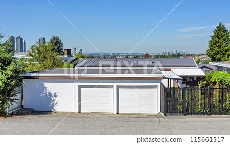 Double garage and backstreet entrance of family house with Vancouver downtown on the horizon 115661517