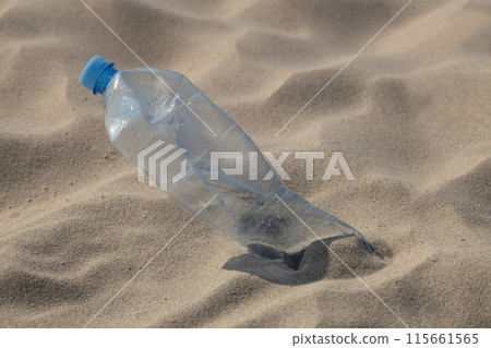 Plastic Bottle on Sandy Beach. Plastic Bottle on Sandy Beach. 115661565