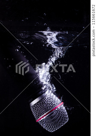 A microphone splashing into the water. Microphone A microphone splashing into the water. Microphone 115661672