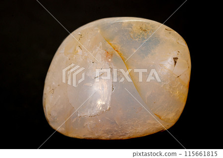 Macro stone opal mineral on a black background Macro stone opal mineral on a black background 115661815