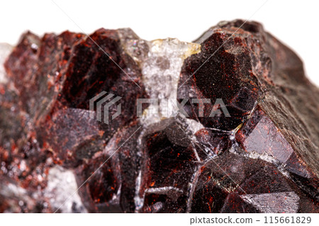 Macro stone garnet mineral on white background 115661829