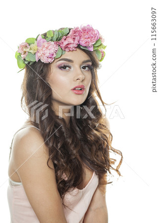 Posing brunette woman with fresh flower on her head. Spring, cosmetic, beauty 115663097