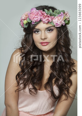 Glorious brunette woman with fresh flower on her head. Spring, cosmetic, beauty, skin care 115663099