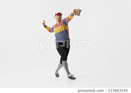 Full-length image of young guy, baseball player in serving ball, training with concentration and determination isolated on white background. 115663545