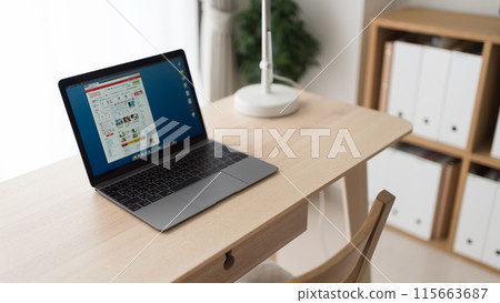 A room with a laptop and a desk 115663687