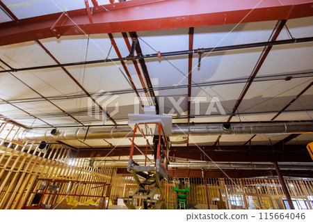 In progress renovations to interior of building after demolition with broken internal ceilings 115664046