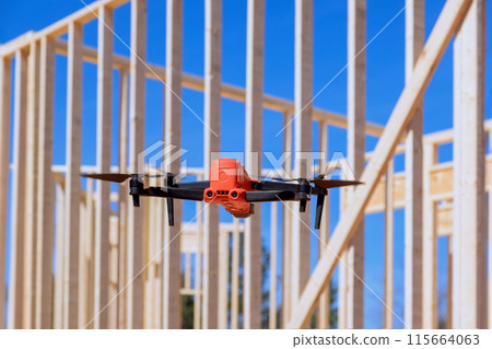 Drone is used by contractor supervisor to inspect construction work at construction site 115664063