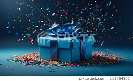 There is a blue gift box with a satin bow on a blue background. Multi-colored confetti is falling from above 115664502