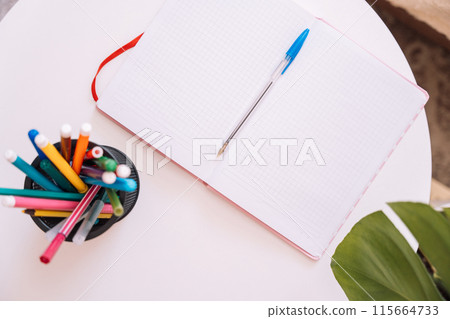 Notepad with stationery on the table 115664733
