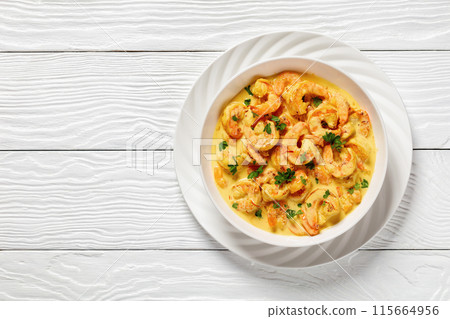 Sauteed Shrimp in creamy saffron sauce, top view 115664956