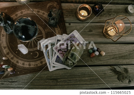 Esoteric Tarot and Crystal Ball Setup with Mystical Decor. Esoteric Tarot and Crystal Ball Setup with Mystical Decor. 115665025