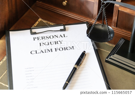 Personal Injury Claim Form on a Lawyer's Desk. 115665057