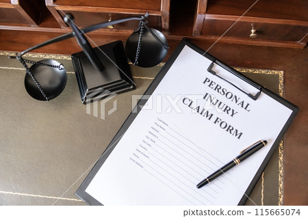 Personal Injury Claim Form on a Lawyer's Desk. Personal Injury Claim Form on a Lawyer's Desk. 115665074
