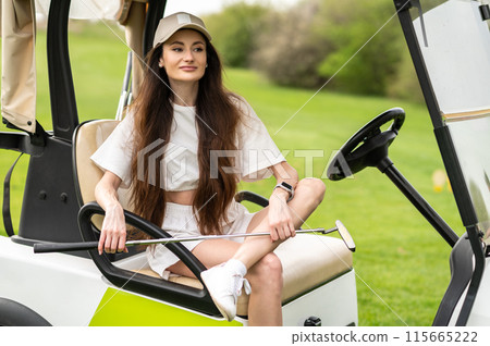 Active woman standing by the vehicle with golf in nature 115665222