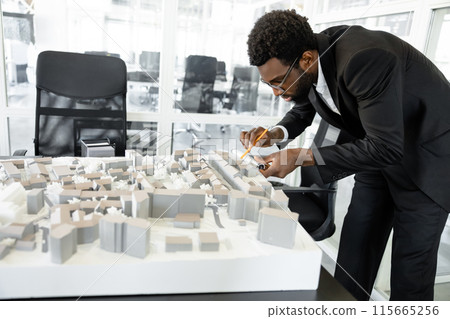 Hard working man architect conceptualizing new exterior designs in the office 115665256
