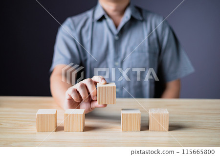 hand of a businessman hold wood empty five blocks with copy space for text or symbols, development concept for growth success process. 115665800