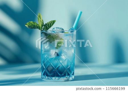A blue Mojito drink in a crystal glass against a blue background with shadows 115666199
