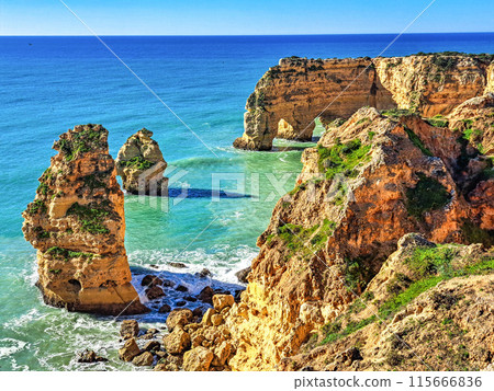 Praia da Marinha Beach among rock islets and cliffs seen from Seven Hanging Valleys Trail, Algarve, Portugal Praia da Marinha Beach among rock islets and cliffs seen from Seven Hanging Valleys Trail, Algarve, Portugal 115666836