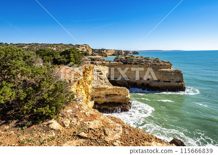 Praia da Marinha Beach among rock islets and cliffs seen from Seven Hanging Valleys Trail, Algarve, Portugal Praia da Marinha Beach among rock islets and cliffs seen from Seven Hanging Valleys Trail, Algarve, Portugal 115666839